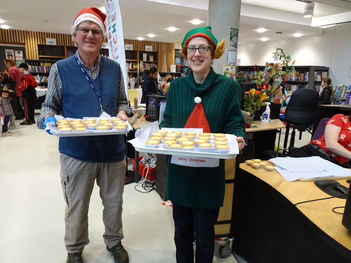 Andrew Roberts and Jenny Blackhurst distributing mince pies, Clay Farm Centre Christmas Fair. Photo: Wendy Roberts, 9 December 2023.